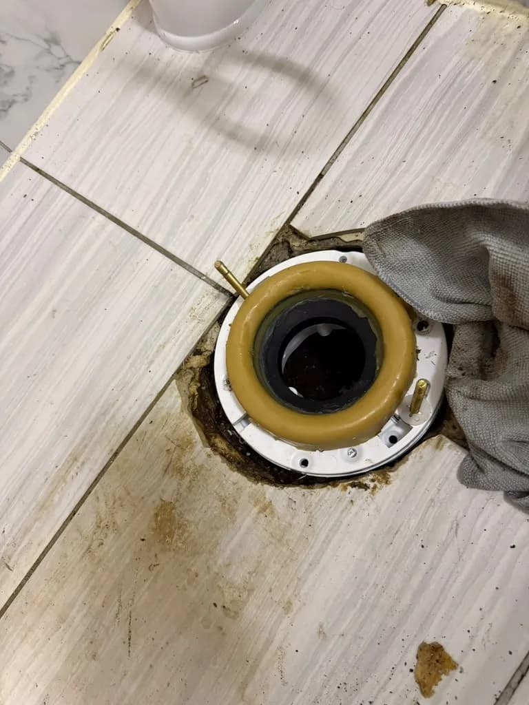 New wax ring seated on a toilet floor flange before installation