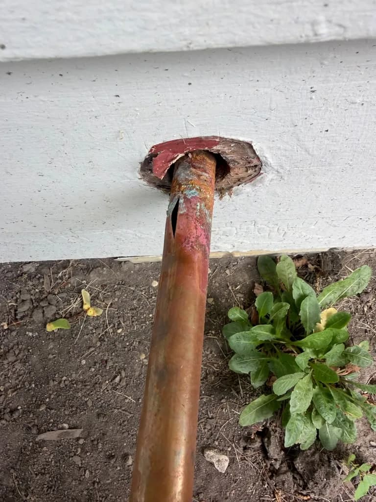 Copper pipe for an outdoor hose bib installed through exterior siding